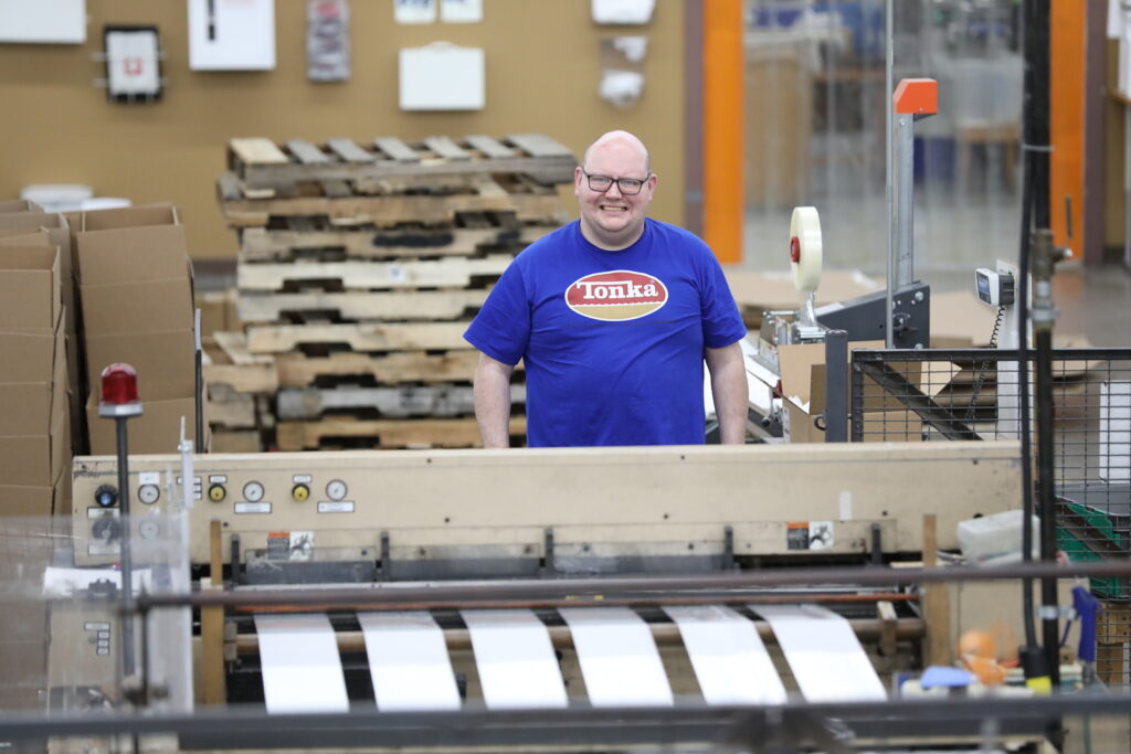 JM Murray staff member at bag machine