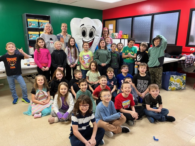 school kids smiling around a character, Mighty Molar